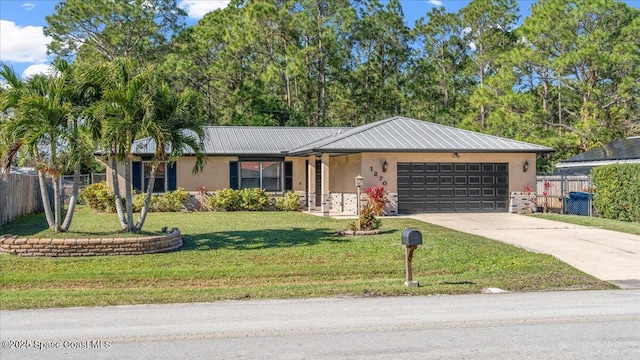 ranch-style home featuring a front lawn and a garage