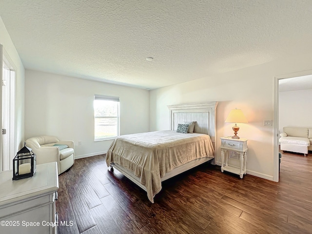 bedroom featuring a textured ceiling and dark hardwood / wood-style floors