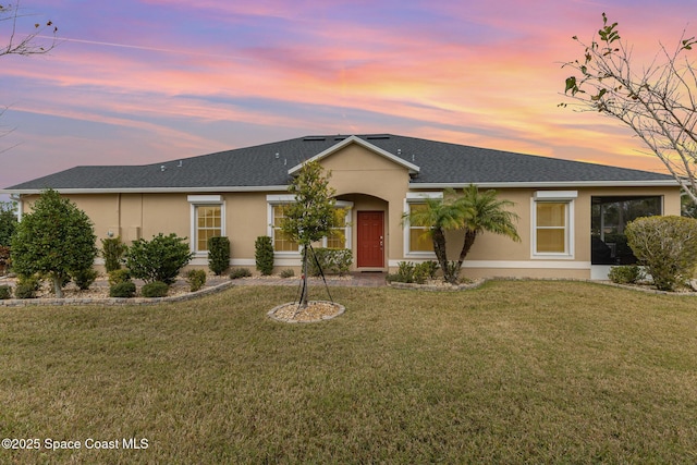 ranch-style house featuring a lawn