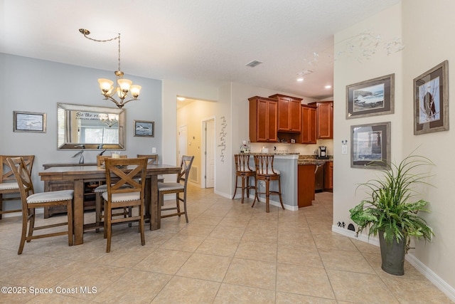 dining space featuring an inviting chandelier and light tile patterned flooring