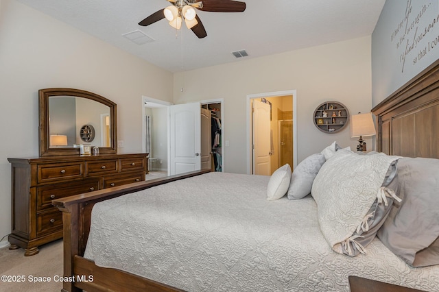 carpeted bedroom with a walk in closet, a closet, and ceiling fan