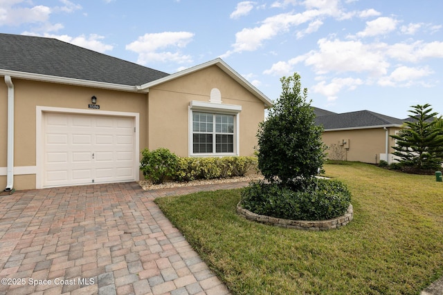 single story home featuring a front yard and a garage