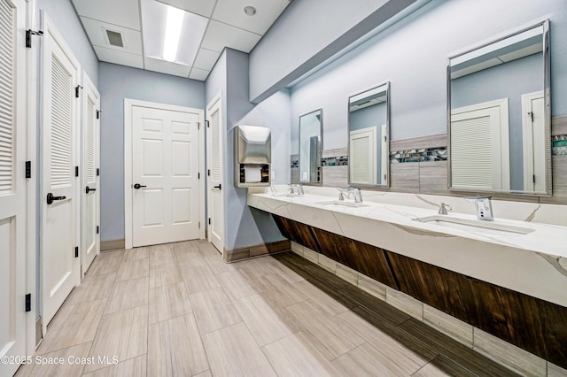 bathroom with vanity and a drop ceiling