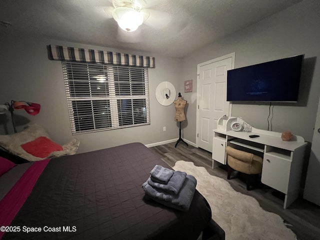 bedroom with ceiling fan and wood-type flooring