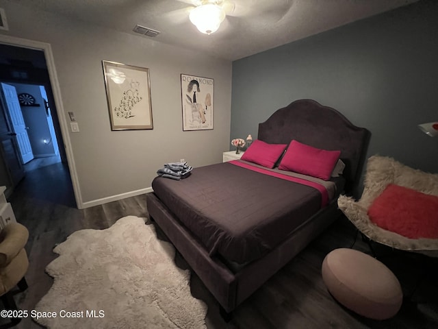 bedroom with ceiling fan and dark hardwood / wood-style floors