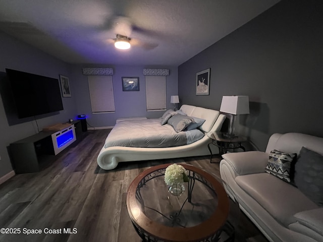 bedroom with ceiling fan and dark wood-type flooring