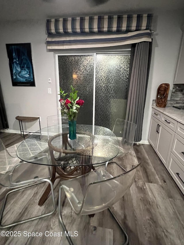 dining area featuring dark wood-type flooring