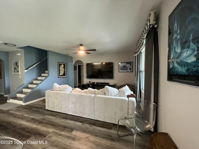 living room featuring dark hardwood / wood-style flooring and ceiling fan