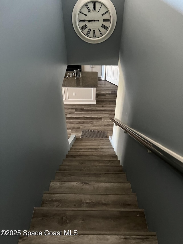 stairs with hardwood / wood-style floors