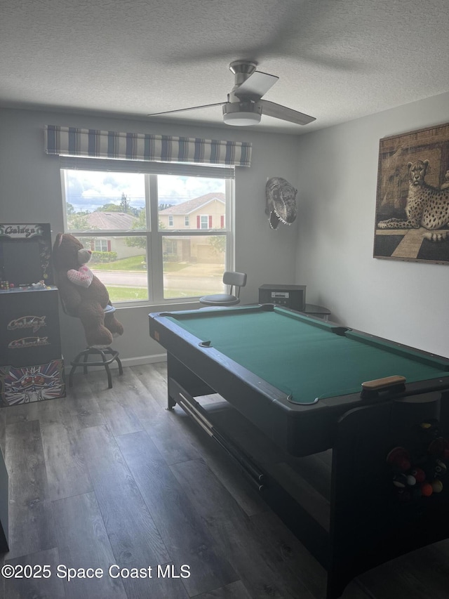 rec room featuring ceiling fan, dark hardwood / wood-style floors, a textured ceiling, and pool table