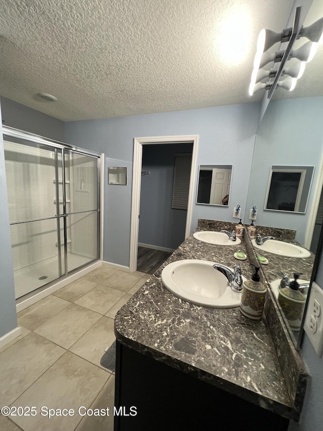 bathroom featuring an enclosed shower, a textured ceiling, vanity, tile patterned flooring, and a chandelier