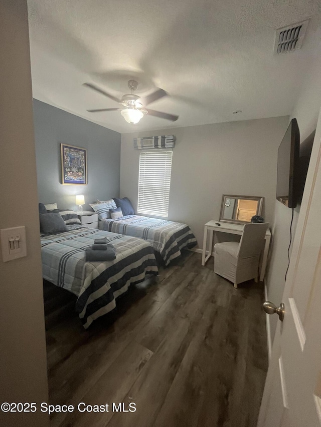 bedroom featuring ceiling fan and dark wood-type flooring