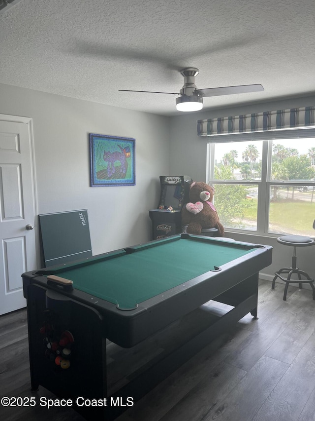 playroom with ceiling fan, a textured ceiling, pool table, and dark wood-type flooring