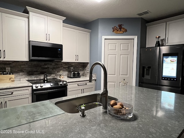 kitchen featuring white cabinets, black range with electric stovetop, sink, a textured ceiling, and stainless steel fridge with ice dispenser