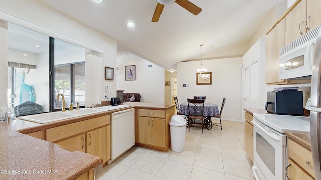 kitchen with light brown cabinetry, sink, pendant lighting, and white appliances