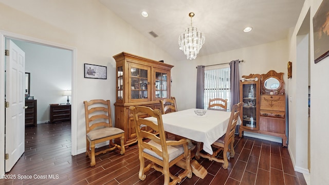 dining space with an inviting chandelier and lofted ceiling