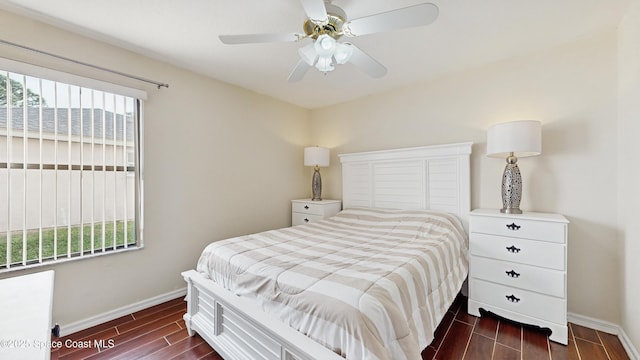 bedroom featuring ceiling fan and multiple windows