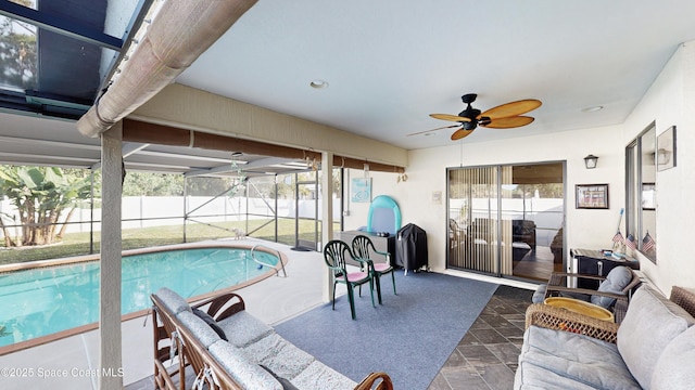 view of swimming pool with ceiling fan and a patio