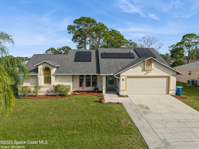 single story home with solar panels, a garage, a front lawn, and central air condition unit