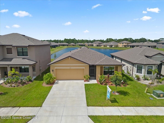 view of front of property featuring a front lawn, a water view, and a garage