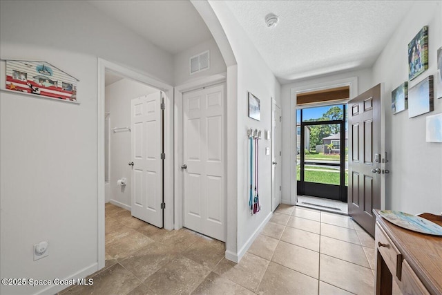 entryway featuring a textured ceiling