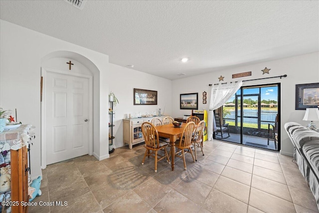 dining area featuring a textured ceiling