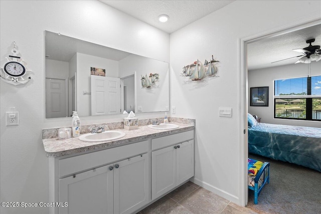 bathroom with vanity, a textured ceiling, and ceiling fan