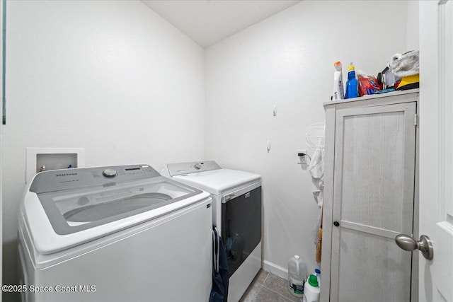 clothes washing area with separate washer and dryer and light tile patterned floors