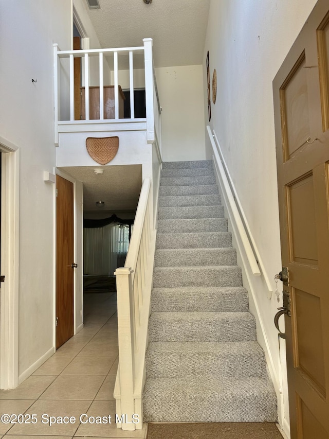 stairs featuring tile patterned floors