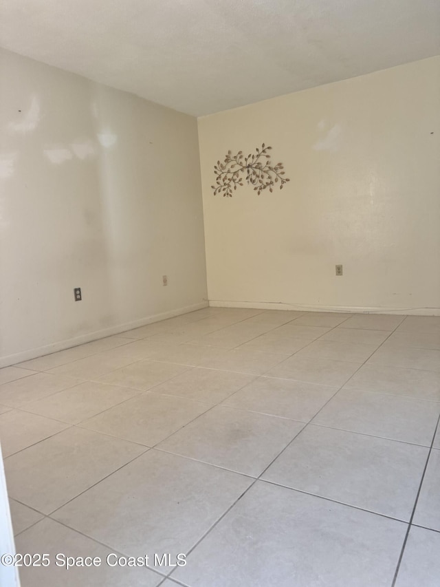 spare room featuring light tile patterned floors