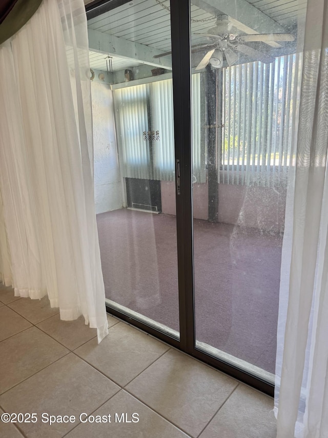 doorway to outside featuring tile patterned flooring and ceiling fan