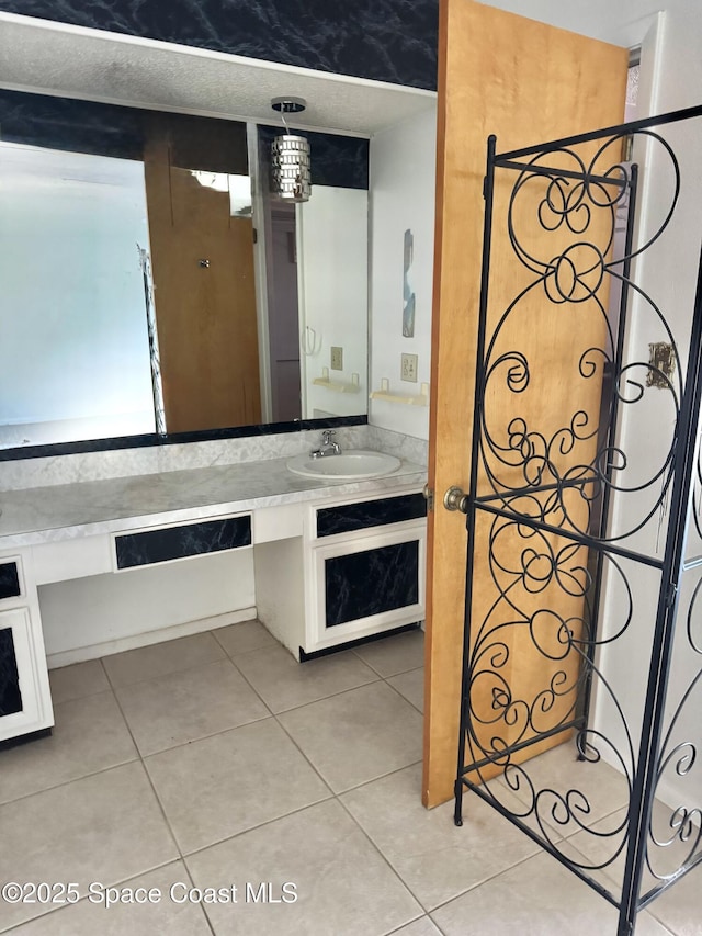 bathroom featuring tile patterned flooring and vanity