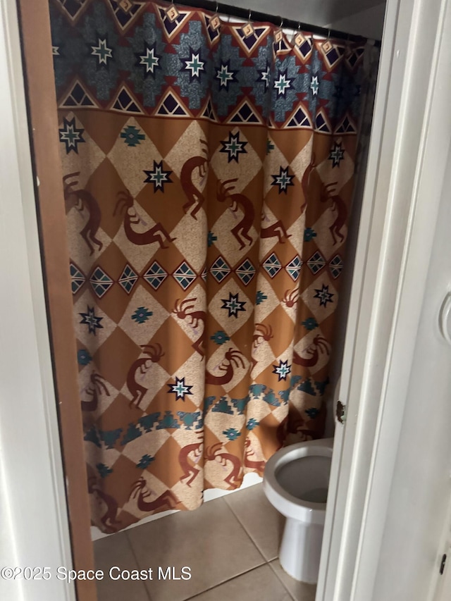 bathroom featuring toilet and tile patterned floors