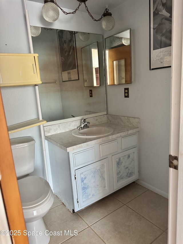 bathroom featuring tile patterned flooring, vanity, and toilet