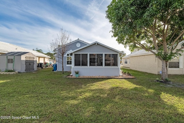 back of house featuring a sunroom and a yard