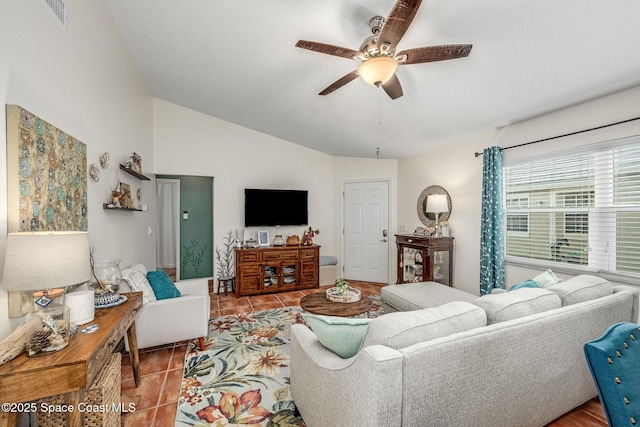 tiled living room with ceiling fan and vaulted ceiling