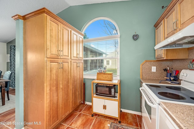 kitchen featuring decorative backsplash, vaulted ceiling, white range with electric stovetop, black microwave, and light tile patterned floors