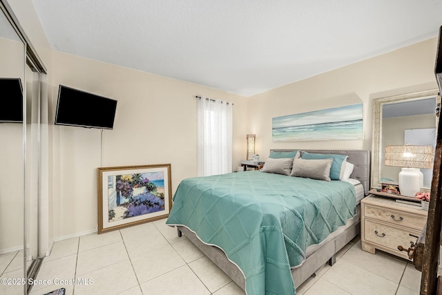 bedroom with a closet and light tile patterned floors