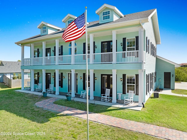 view of front of home featuring covered porch and a front yard