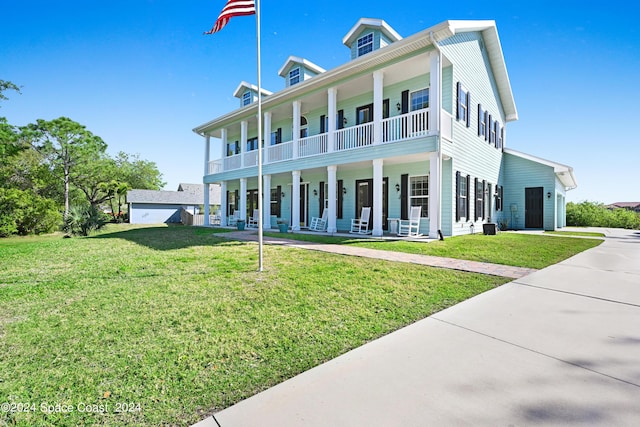 view of front of house with covered porch and a front yard