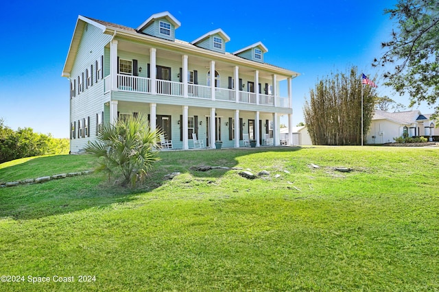 view of front of property with covered porch and a front lawn