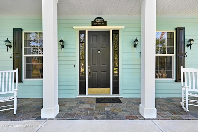 view of exterior entry featuring a porch