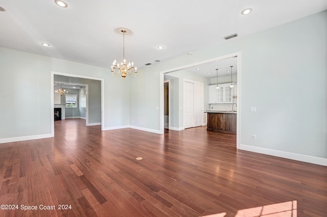 interior space with dark wood-type flooring and a chandelier