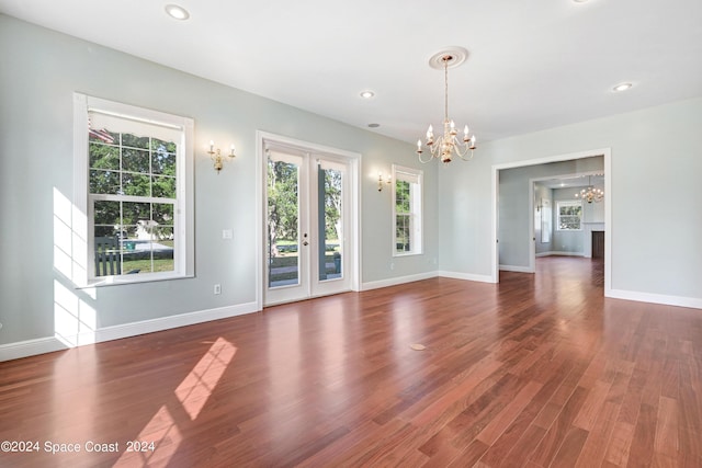 interior space featuring french doors, dark hardwood / wood-style flooring, and a chandelier