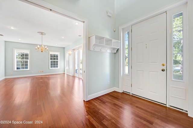 entrance foyer featuring hardwood / wood-style flooring and a notable chandelier