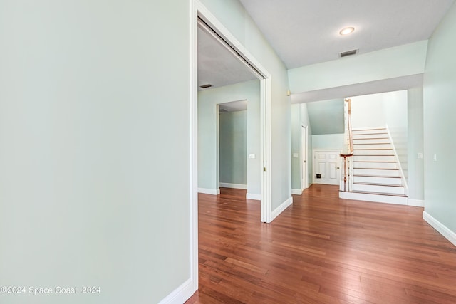 hallway with hardwood / wood-style floors