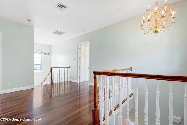 hallway featuring a notable chandelier and dark hardwood / wood-style floors