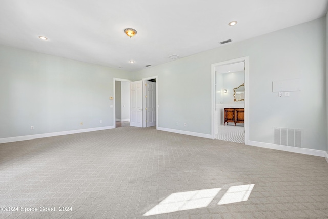 unfurnished bedroom with light colored carpet