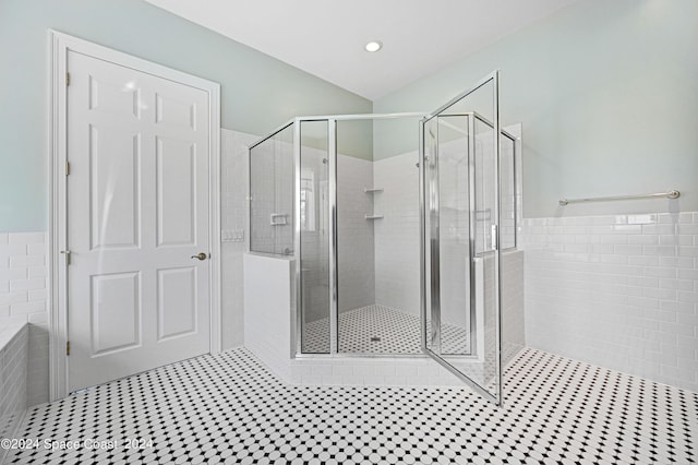 bathroom featuring tile patterned floors and a shower with door