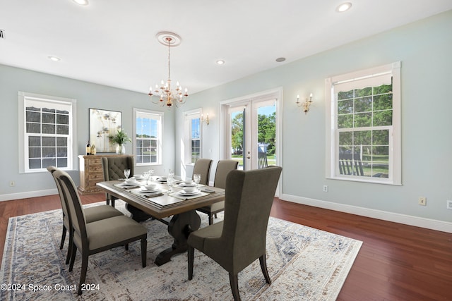 dining space featuring french doors, dark hardwood / wood-style floors, and a chandelier